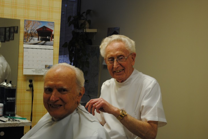 Fred Baade cutting former Indianapolis Mayor William Hudnut’s hair. (Photo by Mark Ambrogi)