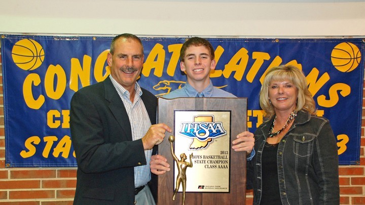 Ryan Cline with his parents after receiving an award last year. 