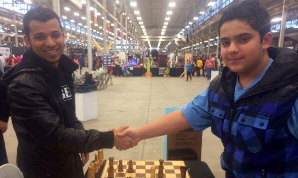 Student from the RACC chess class Sam Neif (right) is playing with visitors of the school booth at the Indiana International Festival last year. (Submitted photo) 