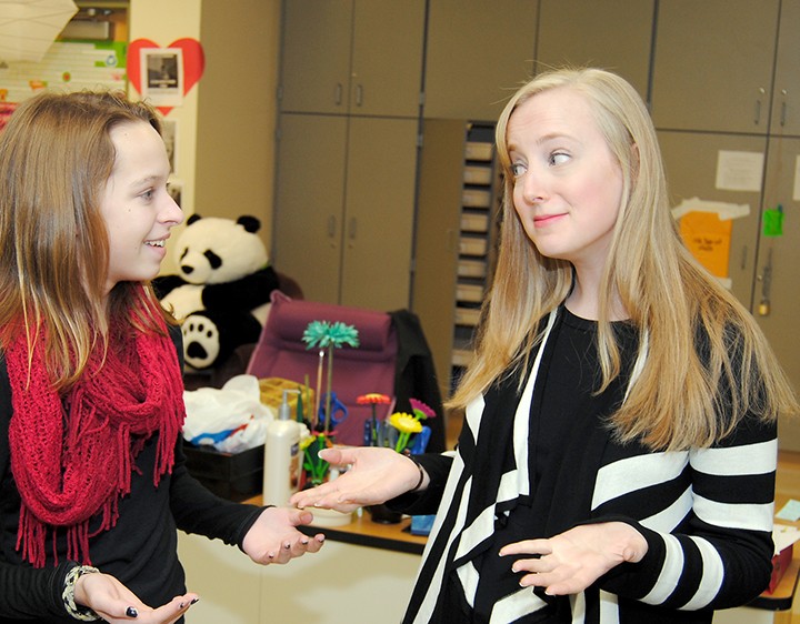Westfield Middle School yearbook teacher Allie Staub, right, talks with eighth-grader Grace Bieghler, a staff member for this year’s and the 2013-14 yearbook. (Photo by Robert Herrington)