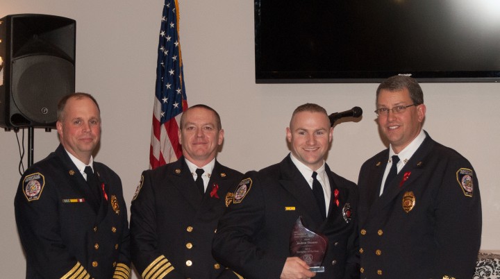 Zionsville Fire Department Deputy Chief Brian Miller (left), Deputy Chief Jeff Beam (second from left) and Chief James VanGorder (right) recognize Andrew Thomas as the Firefighter of the Year. (Submitted photo)