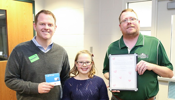 Camille Sidebottom (middle) won a pizza party for her class by nominating fifth-grade teacher Dan Myers (right) as Teacher of the Month. Geoffrey Sherman of BMO Harris Bank presented a $100 cash voucher to Myers. (Photos by Ann Marie Shambaugh