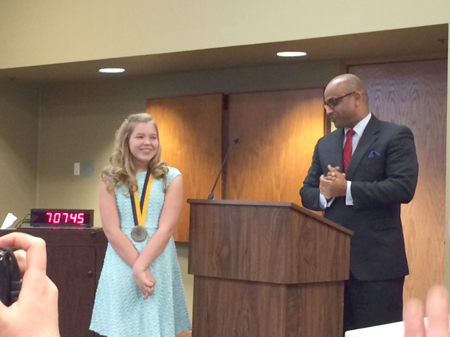 Sixth grader Olivia Keith receives Prudential Spirit of Community award from Reggie Jackson. (Photo by Beth Taylor)