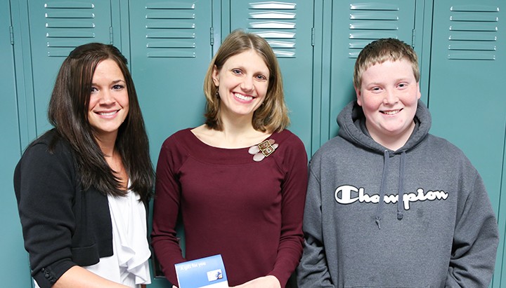 Katrina Garland (left) of BMO Harris Bank presents a $100 cash voucher to Jessica Day (middle), who was named Teacher of the Month after student Yiannis Pappas submitted an essay about her. (Photo by Ann Marie Shambaugh)