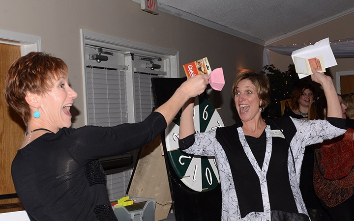 Kirsten Wujek (left) and Libby McCarty celebrate a prize won at Girls’ Night Out. (Submitted photo by Theresa Skutt)