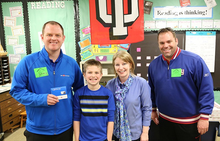 Pleasant View Elementary third-grade teacher Julie Parks (second from right) is the March Teacher of the Month. She was nominated by student Jack Shertzer (second from left). Geoff Sherman (left) of BMO Harris Bank presented a $100 cash voucher to Parks on March 20, and Chris Simone of Amore Pizza provided lunch for Jack’s class. (Photo by Ann Marie Shambaugh)