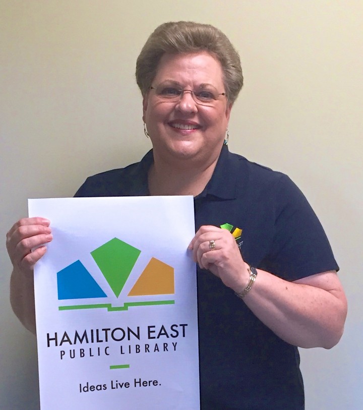 Community Relations Manager Cheryl Jurgens shows off the new Hamilton East Public Library logo. (Photo by Anna Skinner)