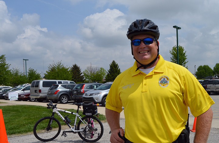 Noblesville police officer Matt Johnston hangs out at the Hamilton County 4-H Fairgrounds May 9 teaching kids about bike safety. (Photo by Michelle Williams)