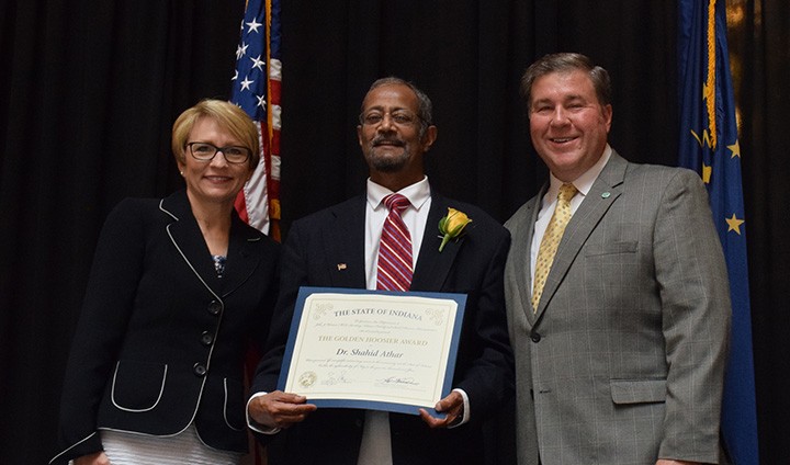 Dr. Shahid Athar, middle, accepts the Golden Hoosier Award from Indiana Lt. Gov. Sue Ellspermann, left, and Dr. John Wernert, secretary of the Indiana Family and Social Services Administrations. (submitted photo)
