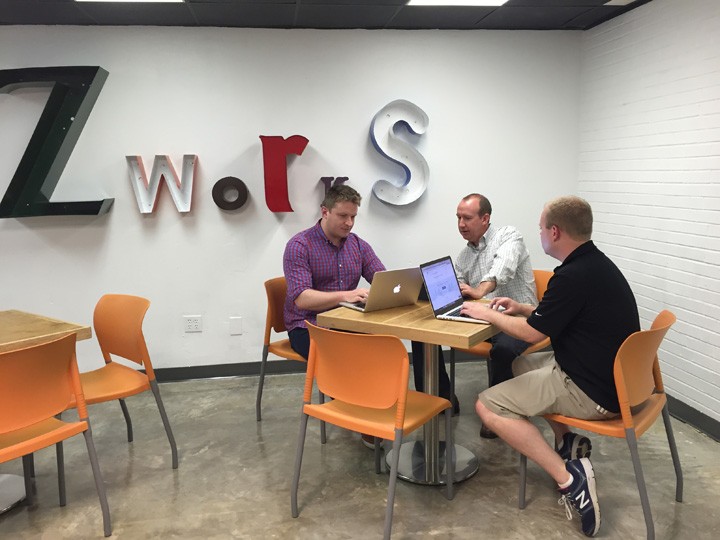 From left, Ian Runyon, director of solutions at MOBI; Jim Martin, managing partner at Venue Intelligence; and Eric Sendelbach, CTO of MOBI; work in one of zWorks collaboration rooms. (Photo by Anna Skinner)