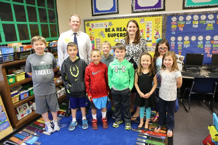 Pleasant View Elementary students Alex Wray, from left, Josiah Nyce, Jack Schulte, Jack Turnbull, Sam Anderson, Allie Miller, Anne Nooning and Phoebe Zucker wrote essays nominating second-grade teacher Kasey Cope as Teacher of the Month. Geoff Sherman, back row left, of BMO Harris Bank presented Cope with a $100 cash voucher. (Photo by Ann Marie Shambaugh)
