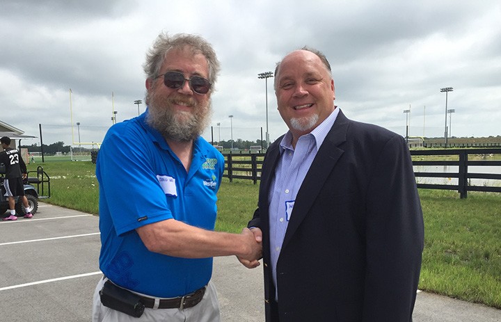 Craig Wood, left, shakes hands with Andy Card, a Jonathan Byrd’s Fieldhouse investor. (Photo by Anna Skinner)
