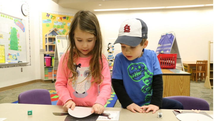 Caroline Cacioppo (left) and Will Ferrand assemble paper penguins in the preschool program at Union Elementary. (Photo by Ann marie shambaugh)