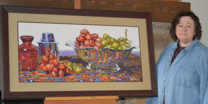 Joyce K. Jensen, with her painting “Grapes in Silver,” watercolor, 18 x 38”. (Submitted photo by Marlena Jensen.)