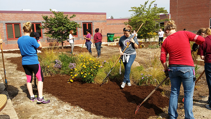 Lawrence Central Key Club students work to beautify the courtyard at Belzer Middle School.. (Submitted photo)