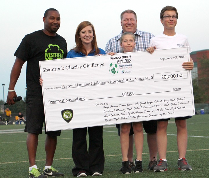 From left: Coach Myron Vaughn, Sara Bailey, from the Peyton Manning Children’s Hospital, and the Ariganello family present a check to St.Vincent for $20,000. (Submitted photo)