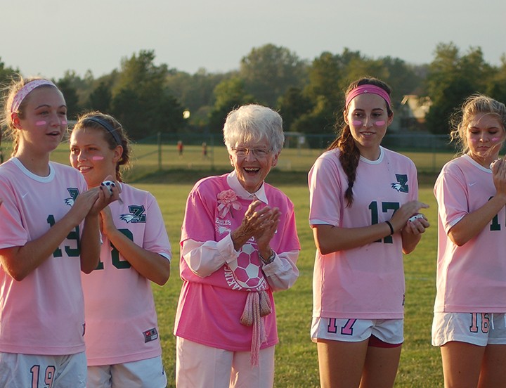 Thirty year survivor Barbara Probasco, wearing the highest jersey number of the evening, is flanked by varsity players Olivia Rent, Alex Wendt, Amelia Wampler and Caitlin Tanona. (Photo by Heather Lusk)