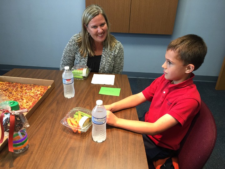 Susan Sponhauer, left, and Adam McNeany celebrate Sponhauer’s nomination with a pizza party between the two of them. (Photo by Anna Skinner)