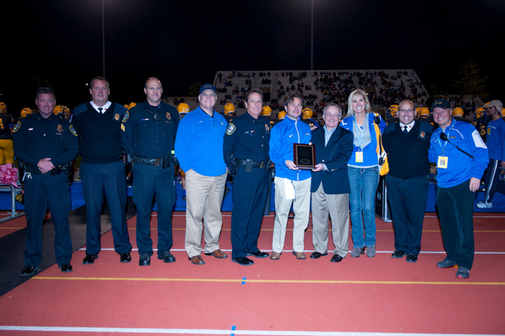 Officials from Carmel High School, the Carmel Police Dept. and the Carmel Fire Dept. accept a plaque in honor of the school’s Sport Event Security Awareness designation. (submitted photo)