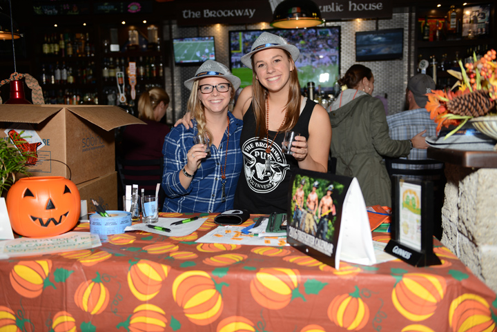 Clare Crumback and Molly Cason hold up their glasses at Brocktoberfest. (Photo by Theresa Skutt)