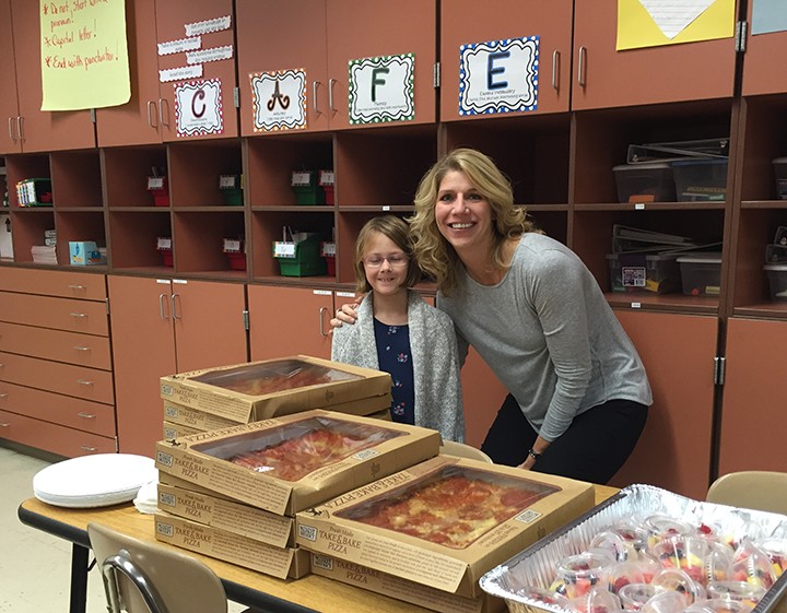 Elise Cramer, left, won her class a pizza party by writing an essay nominating Ann Joseph as Teacher of the Month. (Photo by Anna Skinner)