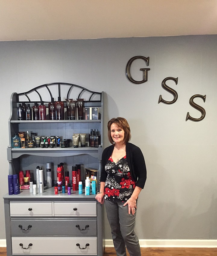 Penny Foster stands next to the merchandise in her new salon, Grand Style Station (Photo by Anna Skinner)