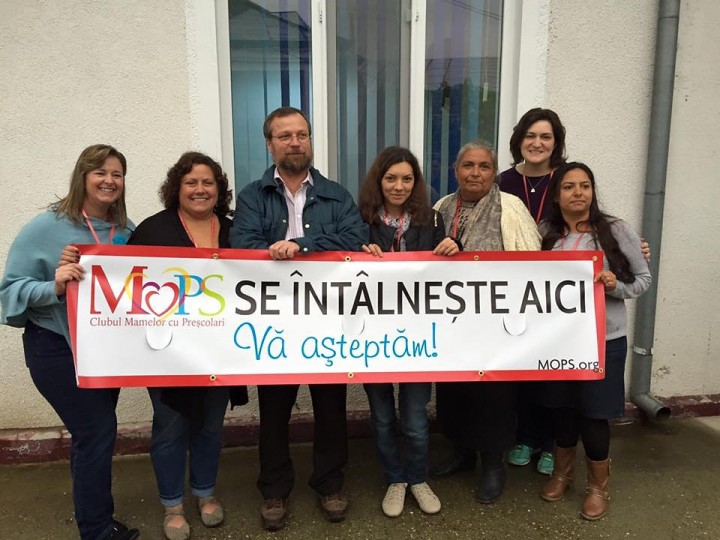 The ZPC team helped launch MOPS at a church in Giurgiu, Romania. Team members include, from left, Michele Sutton, Mindi McMillan and Lisa Price, second from right. The sign states in Romanian, “MOPS meets here. All are welcome.” (Photo by Lisa Price) 