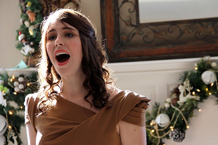 Christina Barnes sings inside a Zionsville home during a previous year’s Carol of Homes. (Photo by Syndii McCreary)