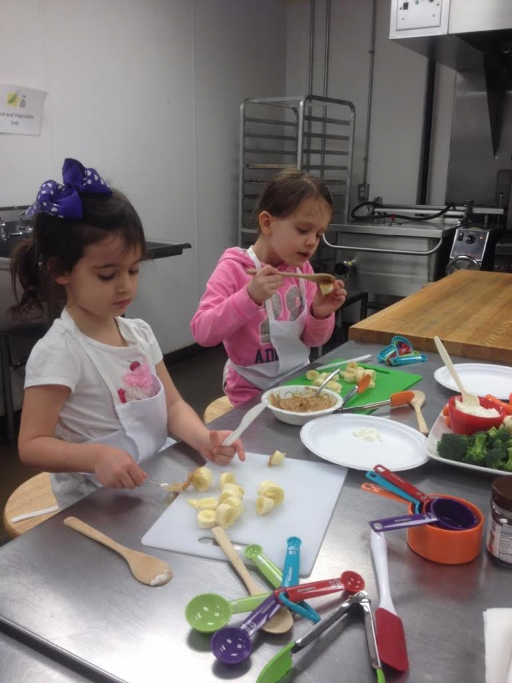 From left, Emma Parcell and Ella Johnson participate in the Kids Rule Cooking School. (submitted photo)