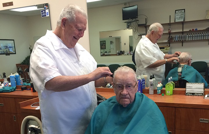 Bill Dennis gives Bill Clark a haircut. Clark comes into the shop every three weeks. (Photo by Mark Ambrogi)