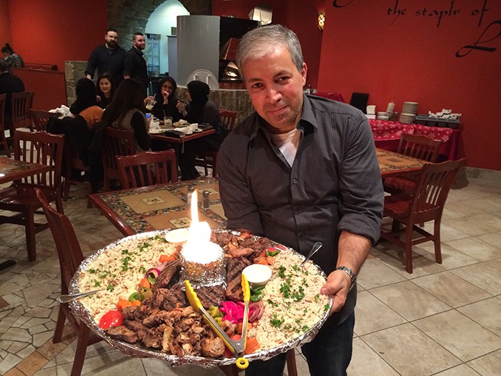 Mezza Medi- terranean Grille owner Charles Saad shows off a party platter at the new Fishers restaurant. (Photo by Michelle Williams)