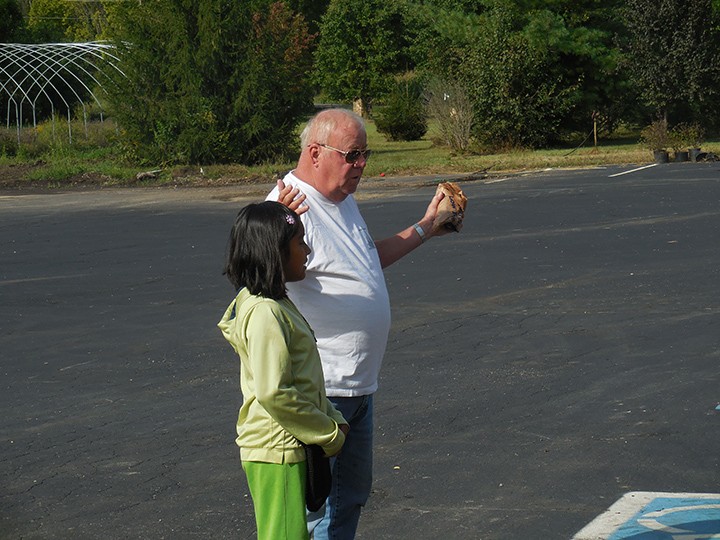 Tim Hahn works with a young girl to translate at one of the Helping Hand events. (Submitted photo)