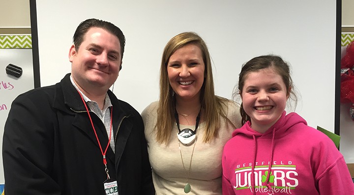 Previous winner, Ellie Kimpel, right, celebrates with teacher Julie Glenn and Market District’s Dan Mixon after Kimpel wrote a 100 word essay nominating Glenn for Teacher of the Month. (Current file photo)