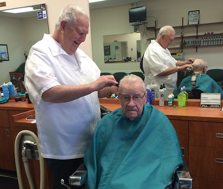 Bill Dennis gives Bill Clark a haircut. Clark goes to the shop every three weeks. (Photo by Mark Ambrogi)