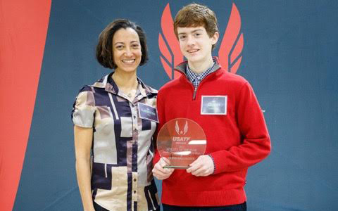 Latashia Key, president of Indiana’s USATF, pauses with Quinn Gallagher as he receives his Athlete of the Year award. (Submitted photo)