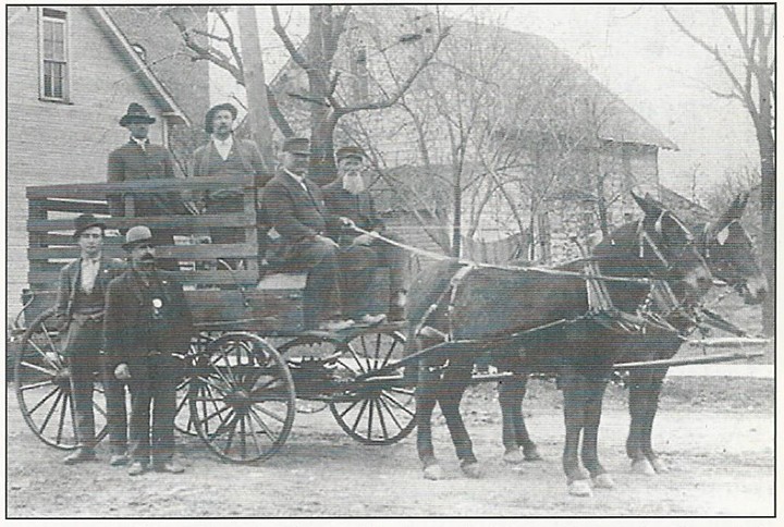 Holding the reins of this mule-drawn wagon is Lew Daughtery with his father, John David Daughtery, who owned a tile factory, next to him. Will Daughtery and Perry Watts, partners in the factory, are in the back. Beside the wagon are Harry Daugherty (Will’s son) and Marshal Bill White. The team is facing west, showing part of the old town hall. (Photo courtesy of Sullivan-Munce Cultural Center)