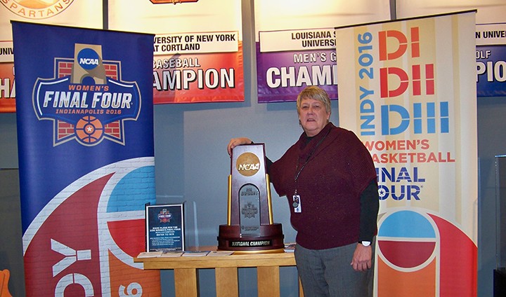 Fishers resident and NCAA director of championships and alliance Tina Krah shows off a replica of the trophy that will be given to this year’s Women’s Final Four champion in Indianapolis. (Photo by Sam Elliott)