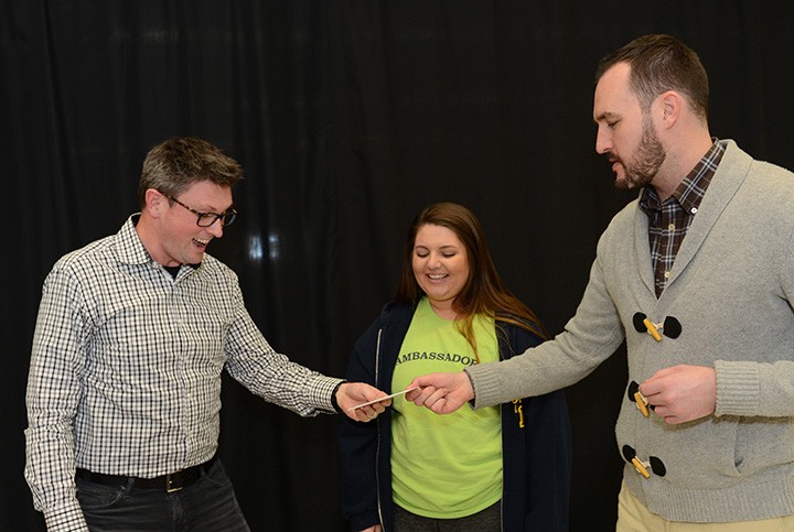Right, Jason Riley of Market District presents CHS choir teacher John Burlace, left, with a gift card for being named Teacher of the Month as Haley Urbanowski, the student who nominated Burlace, looks on. (Photo by Theresa Skutt)