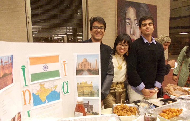 Students from the World Connections Club at HSEHS display information about and share food from India during last year’s International Night event. (Submitted photo)