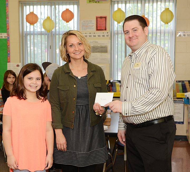 From left, Sophie Reed, Aleks Johnson and Dan Mixan of Market District at the Teacher of the Month party. (Photo by Theresa Skutt)
