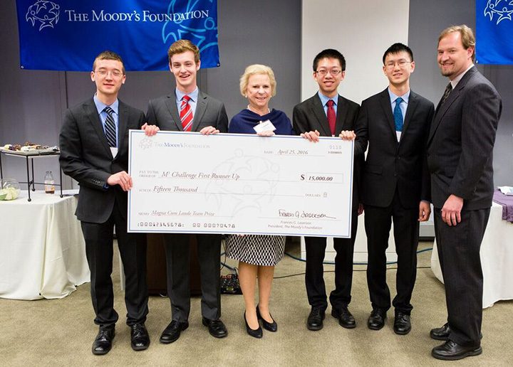 Moody’s Foundation President Fran Laserson, center, presents a $15,000 college scholarship to runners up, from left, Simon Langowski, Joseph Philleo, Miles Dai and Tiger Huang of Carmel High School along with coach Peter Beck. (Submitted photo)
