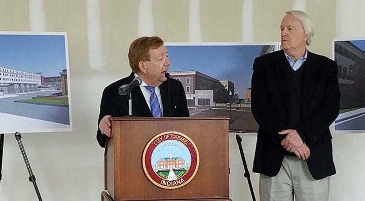 Carmel Mayor Jim Brainard speaks at the groundbreaking for the new parking garage as Pedcor co-chariman/founder Bruce Cordingley looks on. (Submitted photo) 