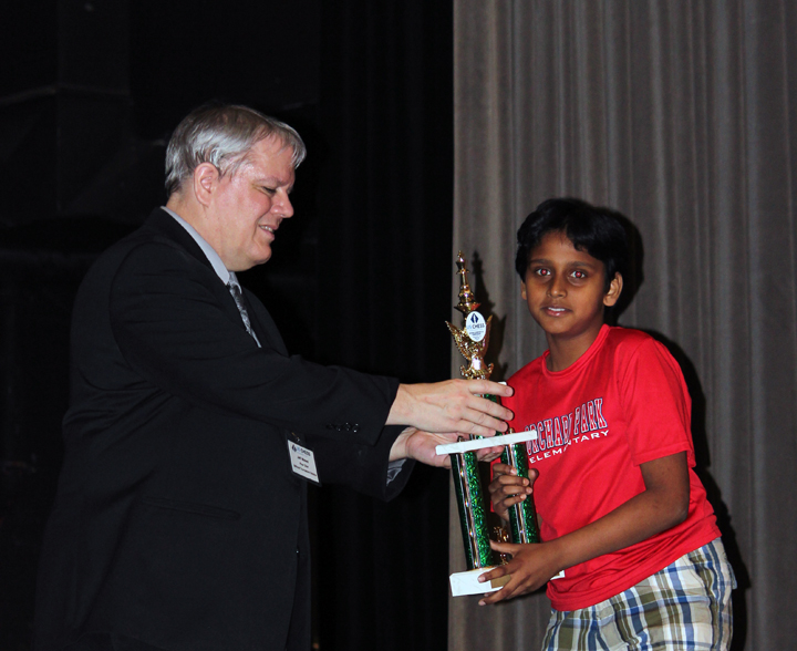 Abhinay Mundrigi accepts a trophy at the National Elementary Chess Championship. (Submitted photo)