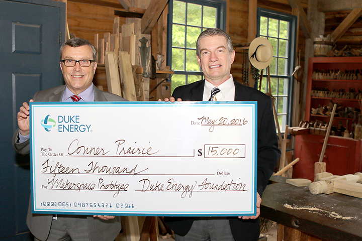 Conner Prairie President and CEO Norman Burns, left, accepts a $15,000 grant from Mark LaBarr, The Duke Energy Foundation’s government and community relations manager for Hamilton County. (Submitted photo)