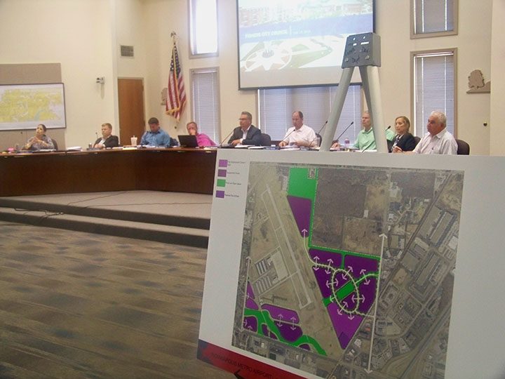 A map depicting the city’s new plan for development of land at the airport is on display at the July Fishers City Council meeting. (Photo by Sam Elliott) CIF-Brandon Dickinson — Fishers’ Director of Economic Development Brandon Dickinson addresses the city council at its July meeting. (Photo by Sam Elliott) 