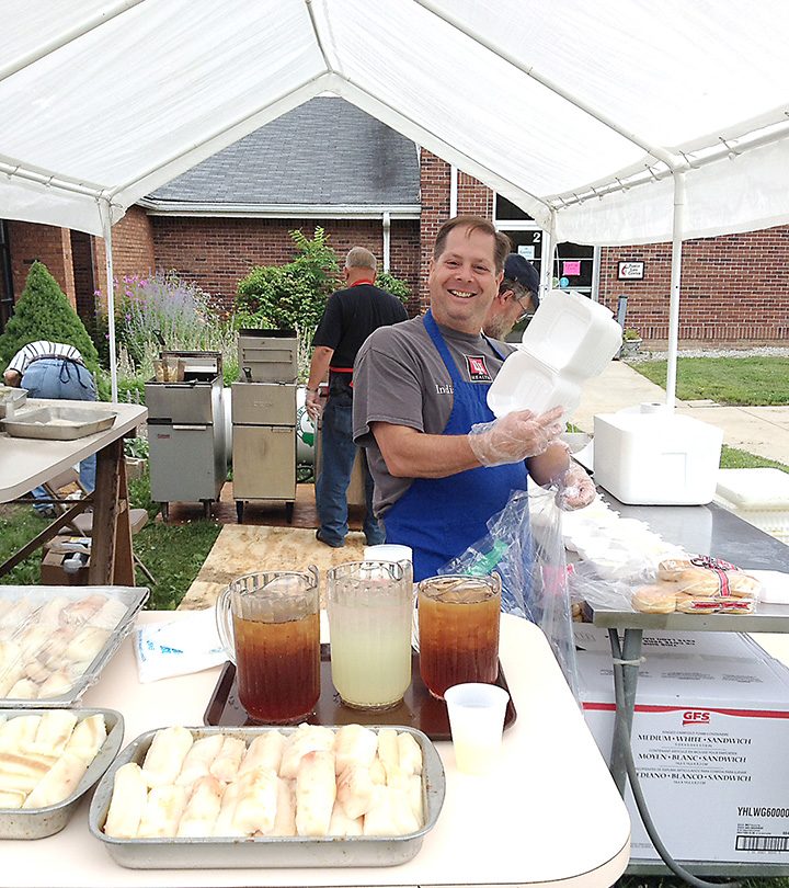 Paul Phillips preps fish to fry at a previous Christ United Methodist Church Fish Fry. (Submitted photo)