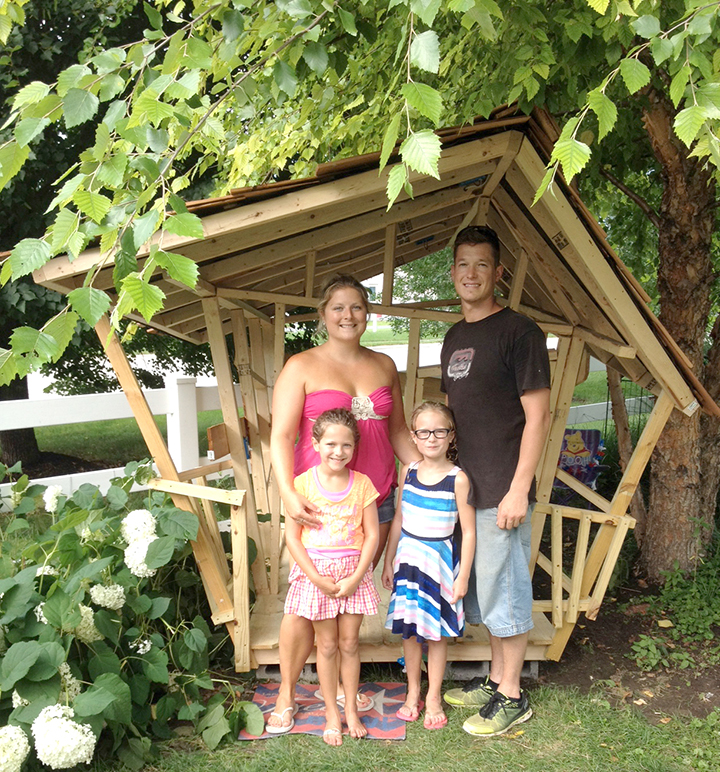 From left, Dawn, Sophieah, Lucy and Michael Klingsmith are building a unique playhouse in their yard. (photo by Kelsey Ligon)