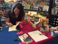 Sydney Scrogham autographs a copy of her book, ‘Chase.’ (Submitted photos)