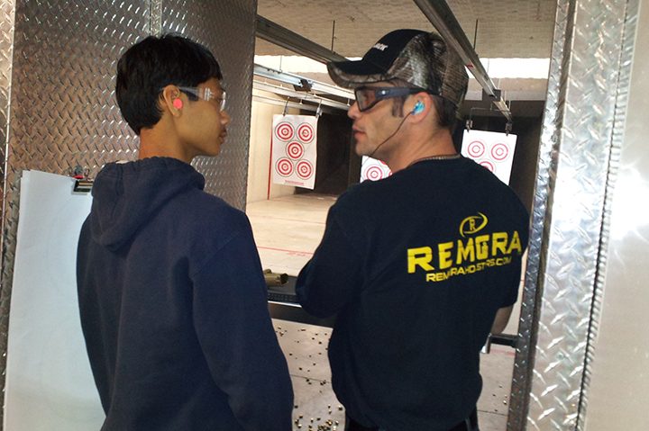 Josh Headlee, right, works with Evan Baur at Tim’s Shooting Academy. (Submitted photo) 