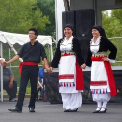 Members of the Senior Hellenic Dance Troupe Nathaniel Martine, FoFo Stergiopoulos and Victoria Martine perform at a past GreekFest. (Submitted photo)